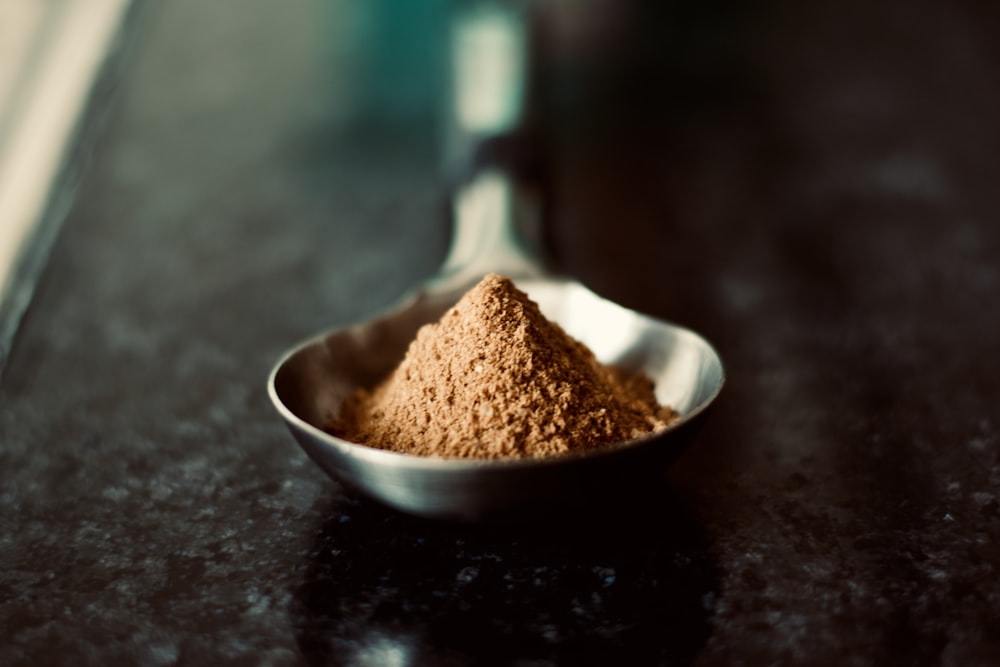 Natural cocoa powder, light to medium brown, close-up texture
