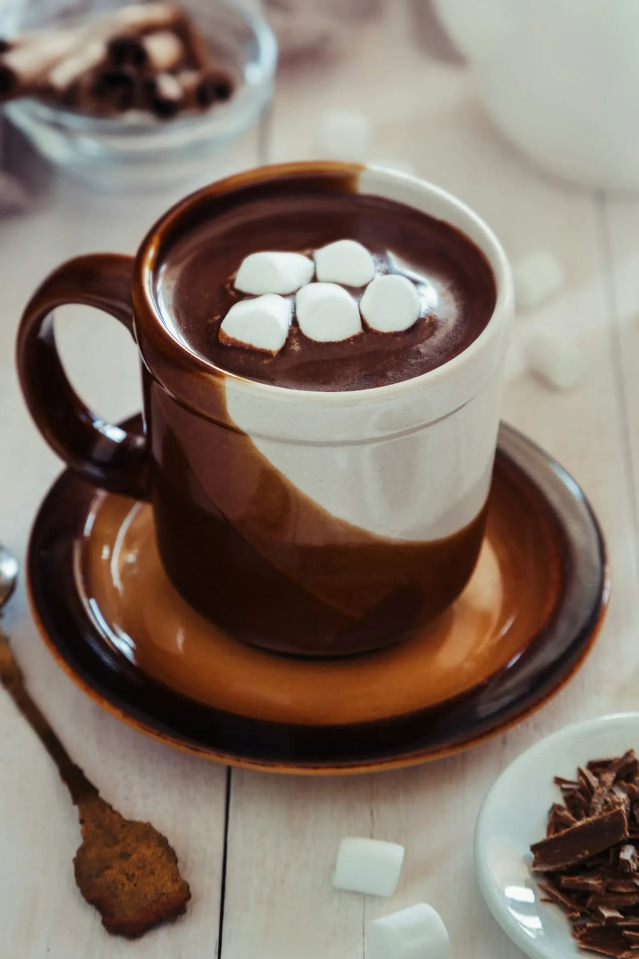 A bright, cozy cup of hot chocolate made with Cocoa Merchant cocoa powder, topped with marshmallows